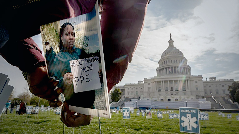 Jamie Roderick, 35, a volunteer for MoveOn, helps place 1,000 signs featuring the faces of nurses and other front-line health-care workers, as well as signs calling for more personal protective equipment (PPE), on the lawn in front of the Capitol on April, 17. MUST CREDIT: photo for The Washington Post by Evelyn Hockstein.