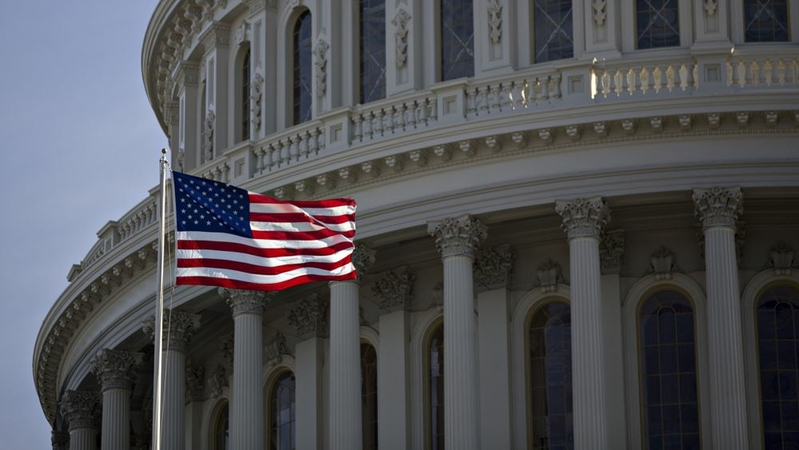 The American flag flies next to the dome of the U.S. Capitol Jan. 15, 2017. MUST CREDIT: Bloomberg photo by Andrew Harrer.