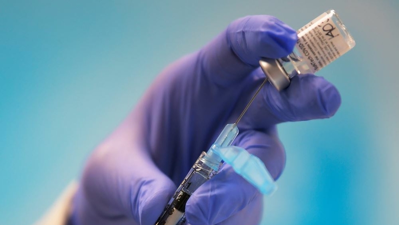 A hospital pharmacist prepares a syringe with the Pfizer vaccine at the Virginia Hospital Center in Arlington on Dec. 16. MUST CREDIT: Washington Post photo by John McDonnell.