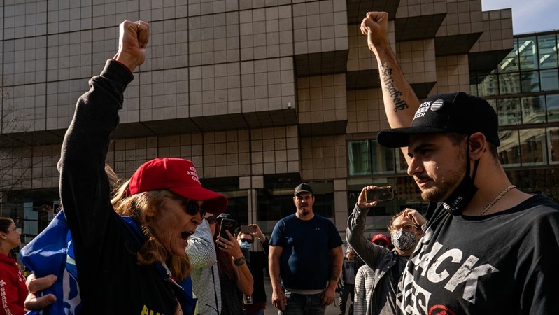 A Black Lives Matter supporter stands near a supporter of President Donald Trump while they protest the presidential vote count outside TFC Center in Detroit on Nov. 6, 2020. MUST CREDIT: Washington Post photo by Salwan Georges