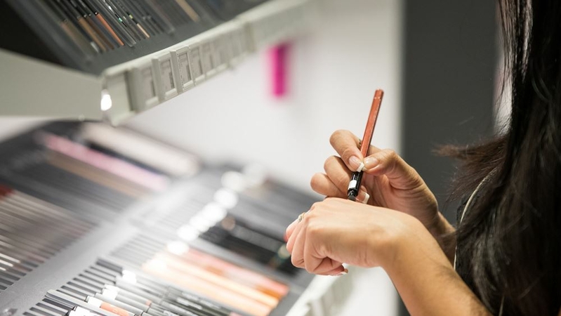 A customer tries an eyeliner at an Amorepacific store in Seoul, South Korea, on Sept. 12, 2018. The pandemic has made cosmetics less central to women's daily routines, ending the wealth created by the rapid rise in popularity of Korean beauty products. MUST CREDIT: Bloomberg photo by SeongJoon Cho