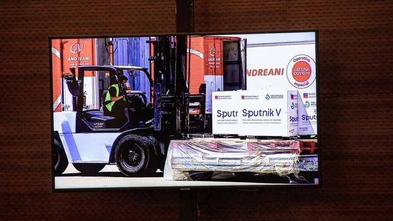 A screen displays images of the Russian Sputnik V vaccine arriving during a press conference at Ezeiza International Airport airport in Buenos Aires, Argentina, on Dec. 24, 2020. Argentina approved the emergency use of Russia's vaccine to combat the spread of Covid-19, becoming the first nation outside the former Soviet Union to authorize the shot. MUST CREDIT: Bloomberg photo by Anita Pouchard Serra