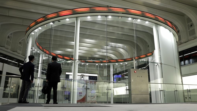 Visitors look at an electronic ticker at the Tokyo Stock Exchange on Oct. 29, 2020. MUST CREDIT: Bloomberg photo by Kiyoshi Ota