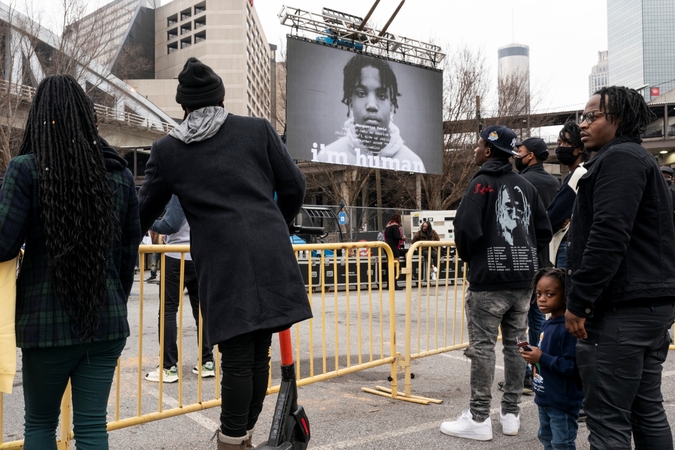  Attendees watch a short video about the importance of voting at a free 
