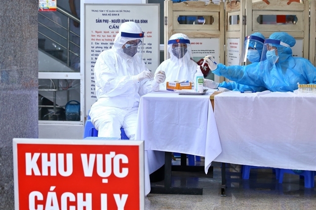 Health workers at a hospital in Hà Nội collect specimens to be tested for COVID-19. — VNA/VNS Photo Minh Quyết