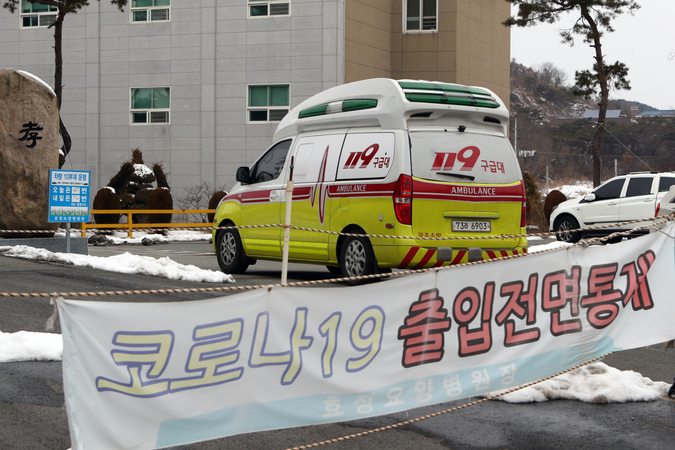 An ambulance is on standby Sunday to transport COVID-19 patients from an elderly care facility in Gwangju to nearby treatment centers. More than 50 confirmed cases have been reported from the elderly care facility by Sunday afternoon. (Yonhap)