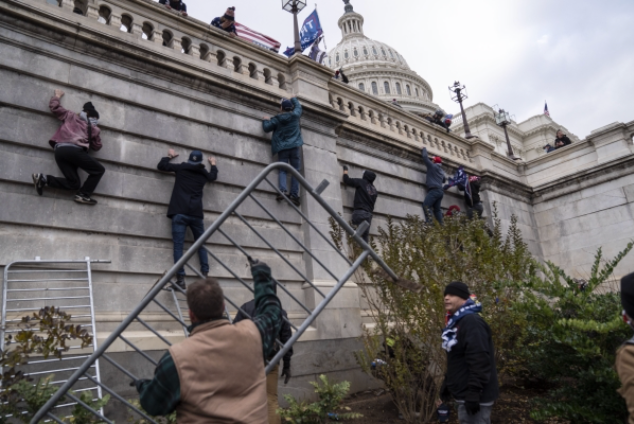 Trump supporters scale the walls on the Senate side of the Capitol on Wednesday, Jan. 6, 2021. MUST CREDIT: Washington Post photo by Michael Robinson Chavez