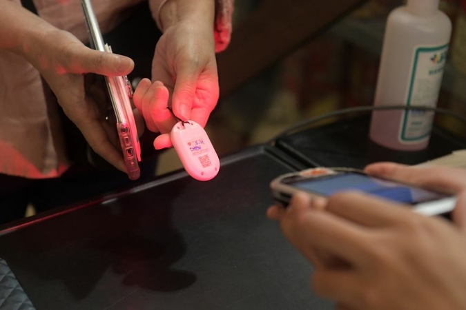 The TraceTogether app and tokens exchange Bluetooth signals in an encrypted and randomised form with nearby users. ST PHOTO: ALPHONSUS CHERN