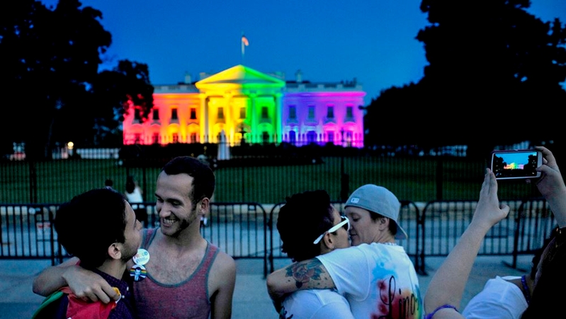 Kelly Miller, left, and her wife, Lindsey Miller, center, embrace on June 26, 2015, outside the White House, lighted in multicolored lights in recognition of the Supreme Court's decision to legalize same-sex marriage in all 50 states. The Millers were married two years ago in Washington State, where same-sex marriage was legalized. MUST CREDIT: Washington Post photo by Michael S. Williamson