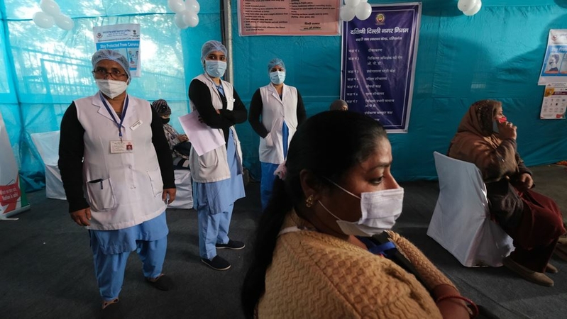 Health workers stand next to volunteers during a nationwide trial of a covid-19 vaccine delivery system at a vaccination center in New Delhi on Jan. 2, 2021. MUST CREDIT: Bloomberg photo by T. Narayan