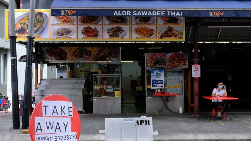 A sign for take-away is displayed outside a restaurant during a nationwide state of emergency in Kuala Lumpur, Malaysia, on Jan, 13, 2021. MUST CREDIT: Bloomberg photo by Samsul Said.