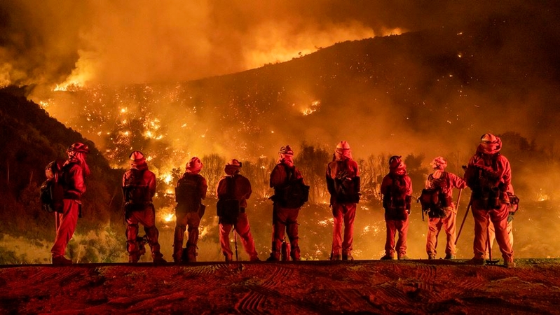 Inmate firefighters watch as the El Dorado Fire burns a hillside near homes in Mountain Home Village, Calif., inside the San Bernardino National Forest on Sept. 9. MUST CREDIT: Photo by Kyle Grillot for The Washington Post.