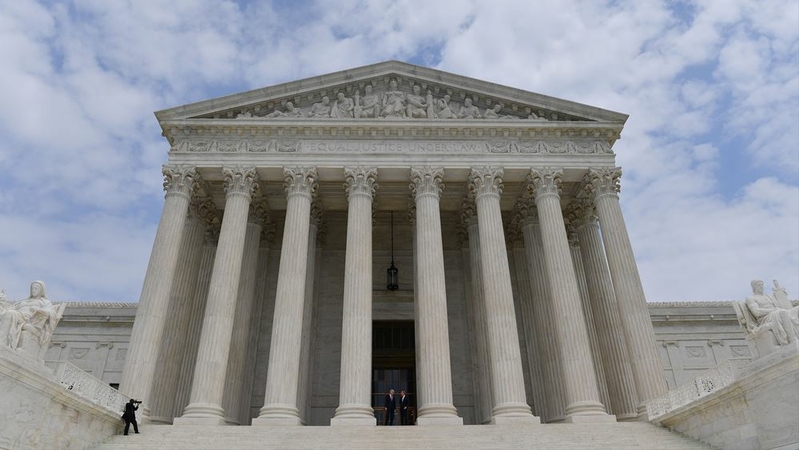 Associate Justice Neil Gorsuch, center left, is accompanied by Chief Justice John Roberts as they walk to the steps of the U.S. Supreme Court on June 15, 2017, in Washington, D.C. MUST CREDIT: Washington Post photo by Ricky Carioti.