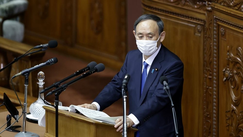Yoshihide Suga, Japan's prime minister, wears a protective face mask as he delivers a policy speech in the lower house of parliament in Tokyo on Jan. 18, 2021. MUST CREDIT: Bloomberg photo by Kiyoshi Ota.