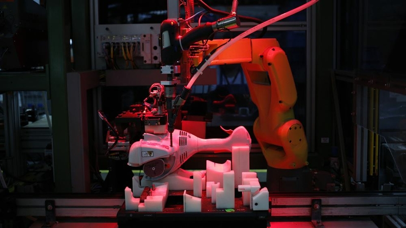 A robot assembles a string trimmer power tool at the Stihl Inc. manufacturing facility in Virginia Beach, Va., on Jan. 11, 2018. MUST CREDIT: Bloomberg photo by Luke Sharrett.