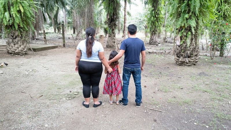 Antonio, Carolina and their daughter Mariel stand in front of the home of Carolina's parents in western Honduras. MUST CREDIT: Washington Post photo by Kevin Sieff