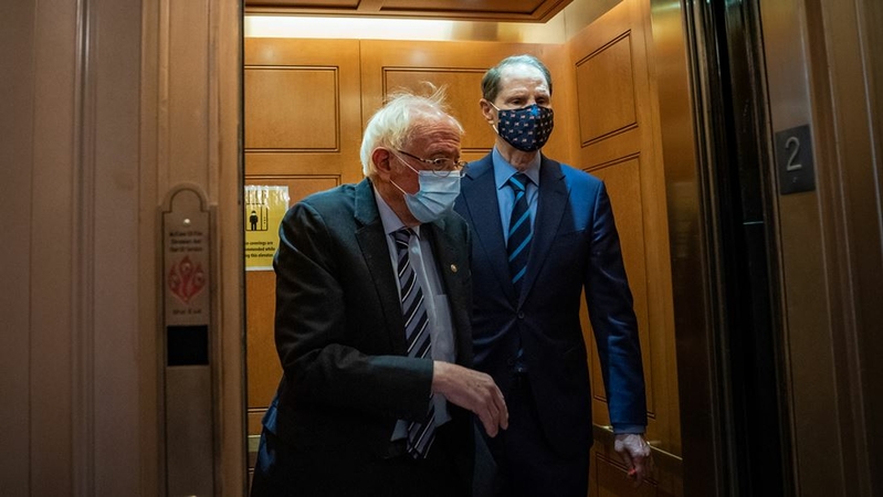 U.S. Sen. Bernie Sanders, I-Vt., and Sen. Ron Wyden, D-Ore., make their way to the Senate floor on the U.S. Capitol Hill on Tuesday, January 26, 2021 in Washington, D.C. MUST CREDIT: Washington Post photo by Salwan Georges