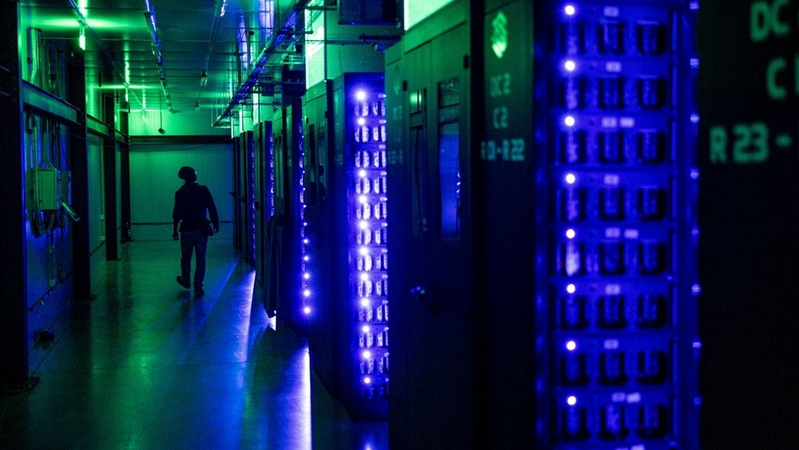 An engineer walks by mining rigs at the Evobits crypto farm in Cluj-Napoca, Romania, on Jan. 22, 2021. MUST CREDIT: Bloomberg photo by Akos Stiller.