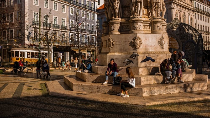 People socialize at Camoes Square ahead of the afternoon curfew in Lisbon, Portugal, on Nov. 22, 2020. MUST CREDIT: Bloomberg photo by Jose Sarmento Matos.