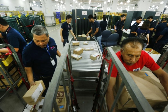 Low-value goods that are worth $400 or less and imported via air or post are currently not subject to GST. PHOTO: ST FILE