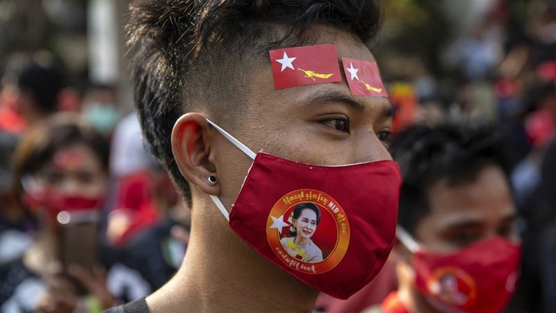 A demonstrator wears a National League for Democracy (NLD) party themed protective mask during a protest outside the Embassy of Myanmar in Bangkok, Thailand, on Feb. 1 2021. MUST CREDIT: Bloomberg photo by Andre Malerba.