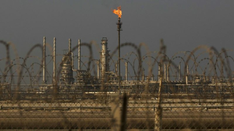 A flame burns off waste gas at Saudi Aramco's Ras Tanura oil refinery and terminal in Ras Tanura, Saudi Arabia, on Oct. 1, 2018. MUST CREDIT: Bloomberg photo by Simon Dawson.