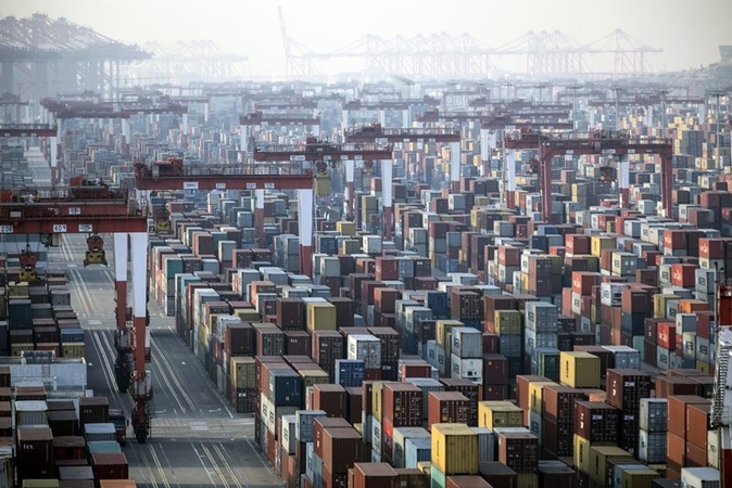 Shipping containers next to gantry cranes at the Yangshan Deepwater Port in Shanghai on Jan, 11, 2021. MUST CREDIT: Bloomberg photo by Qilai Shen.
