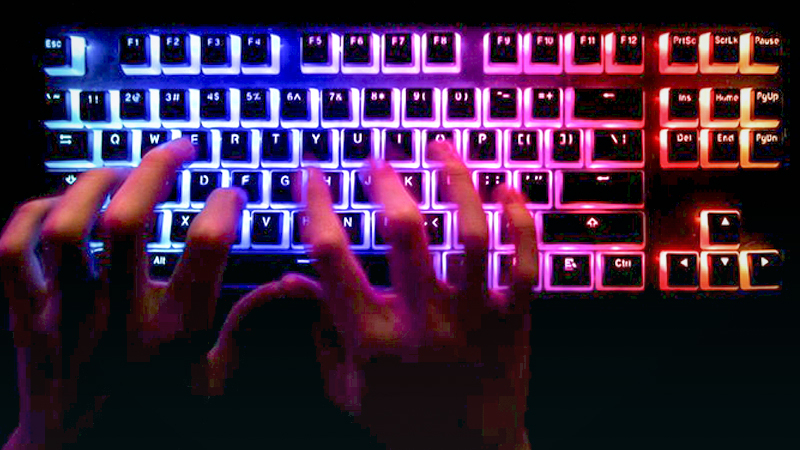 A person typing at a backlit computer keyboard in Danbury, U.K., on Tuesday, Dec. 29, 2020. In the spring, hackers managed to insert malicious code into a software product from an IT provider called SolarWinds, whose client list includes 300,000 institutions. MUST CREDIT: Bloomberg photo by Chris Ratcliffe