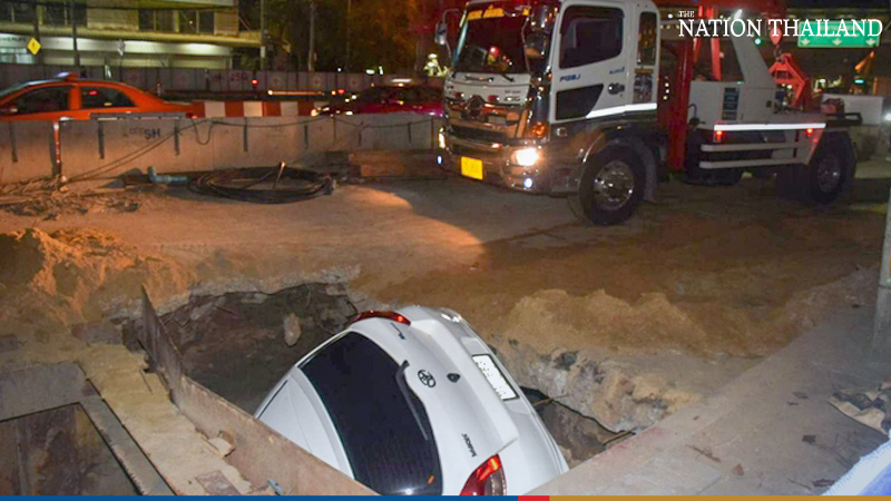 Lucky escape for two as their car nosedives into hole in Bangkok road Lucky escape for two as their car nosedives into hole in Bangkok road