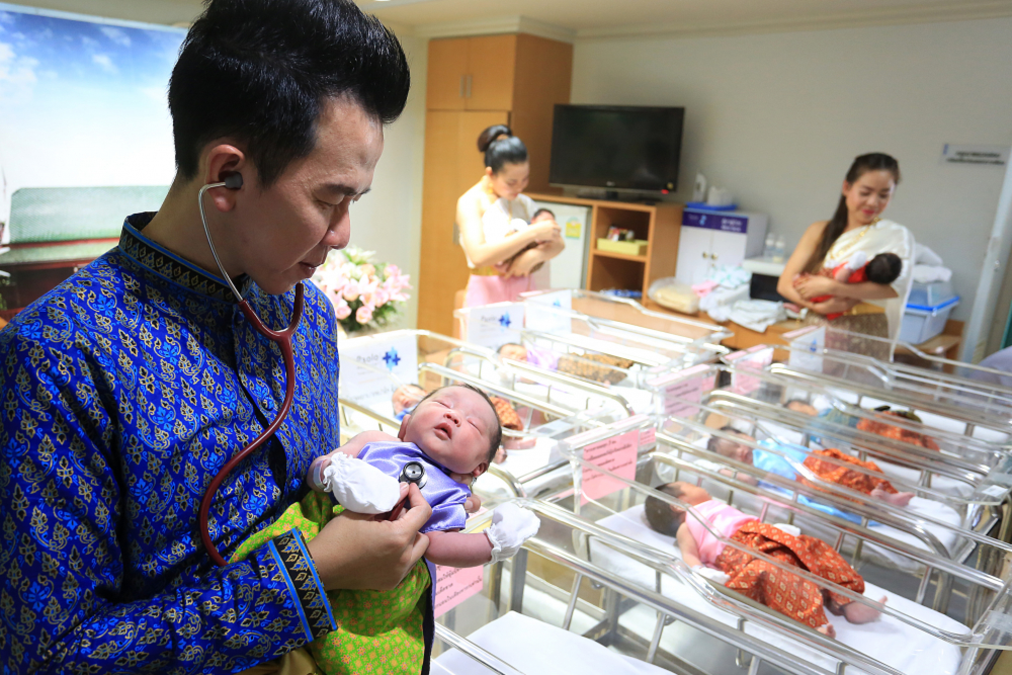 Newborns and medical staff all dressed up for Songkran