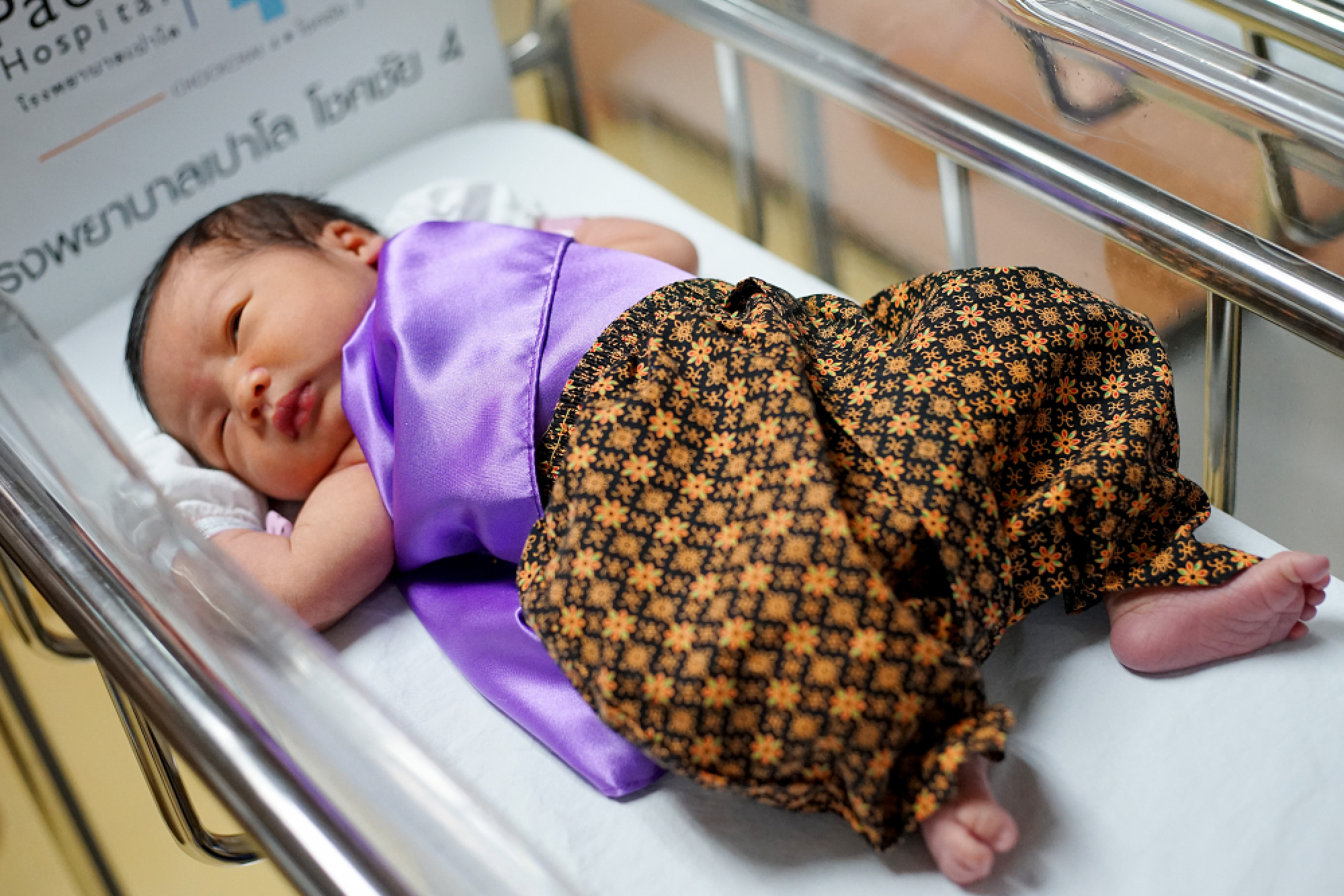 Newborns and medical staff all dressed up for Songkran