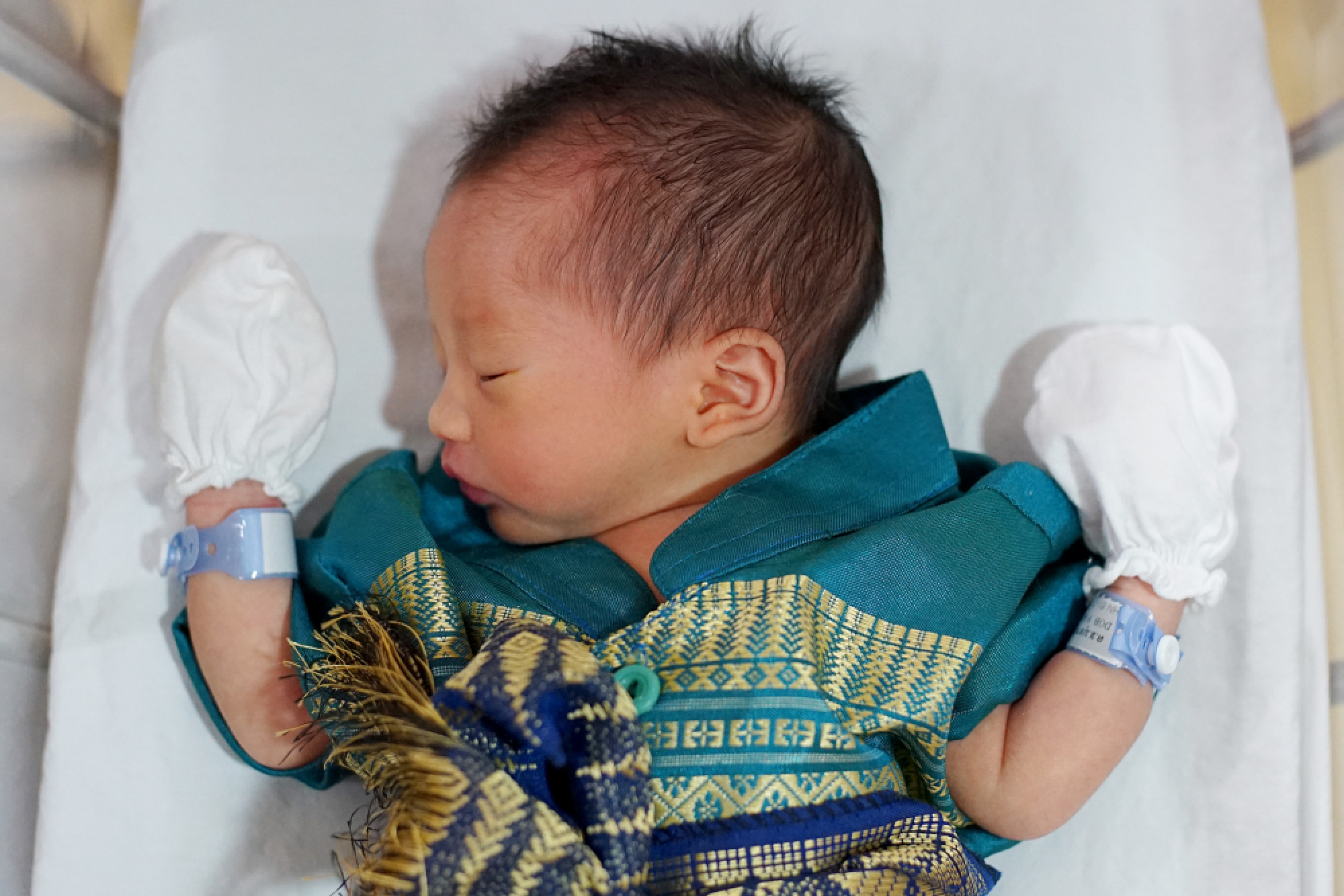 Newborns and medical staff all dressed up for Songkran