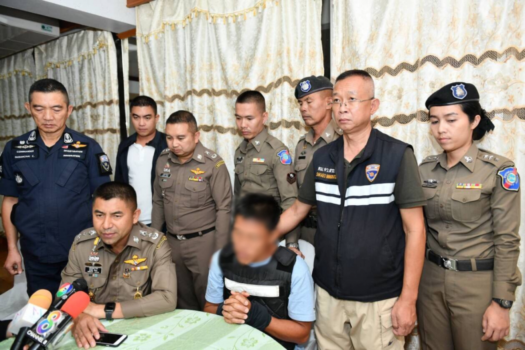 Red-shirt suspect surrenders for alleged murder, bomb attack