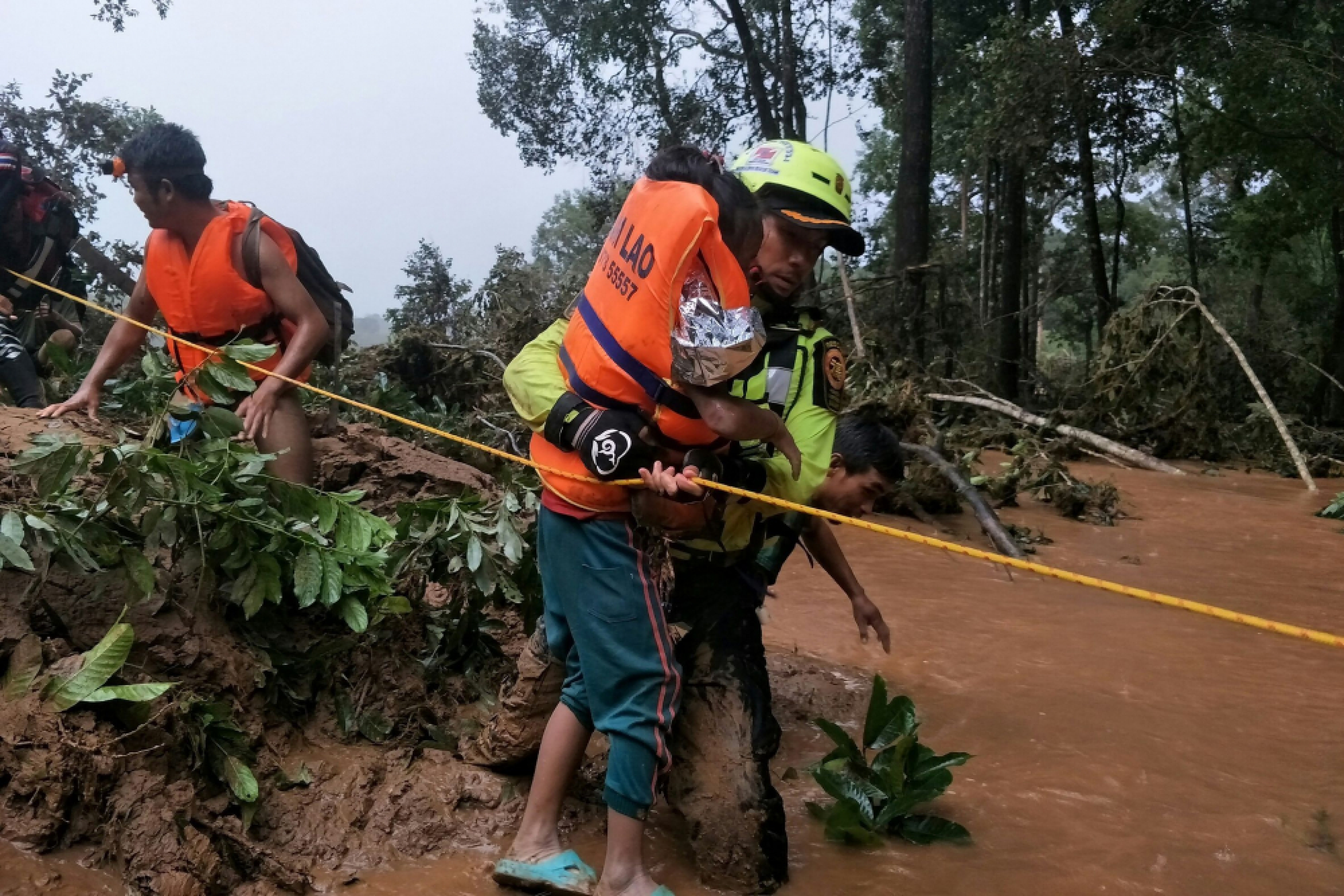 Baby saved from Laos dam disaster by Thai cave rescue volunteers