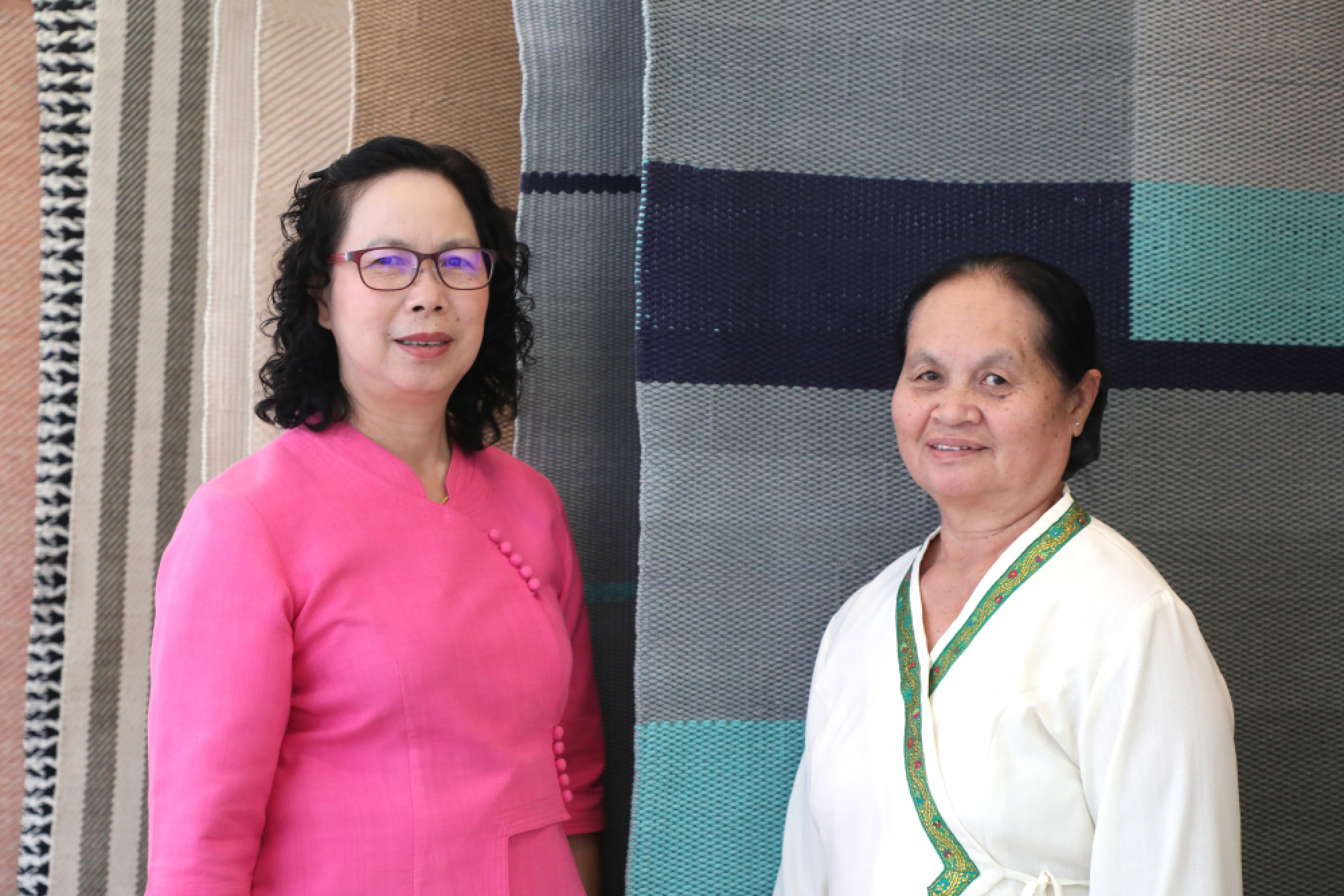 Weavers, left, Saithong and Kham