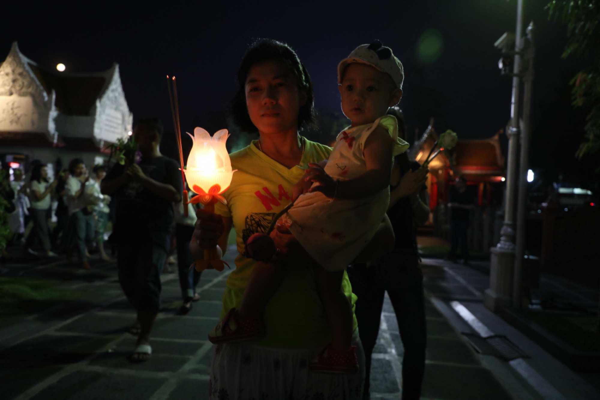 Buddhists take part in a candle-lit circumambulation ceremony to mark Makha Bucha Day