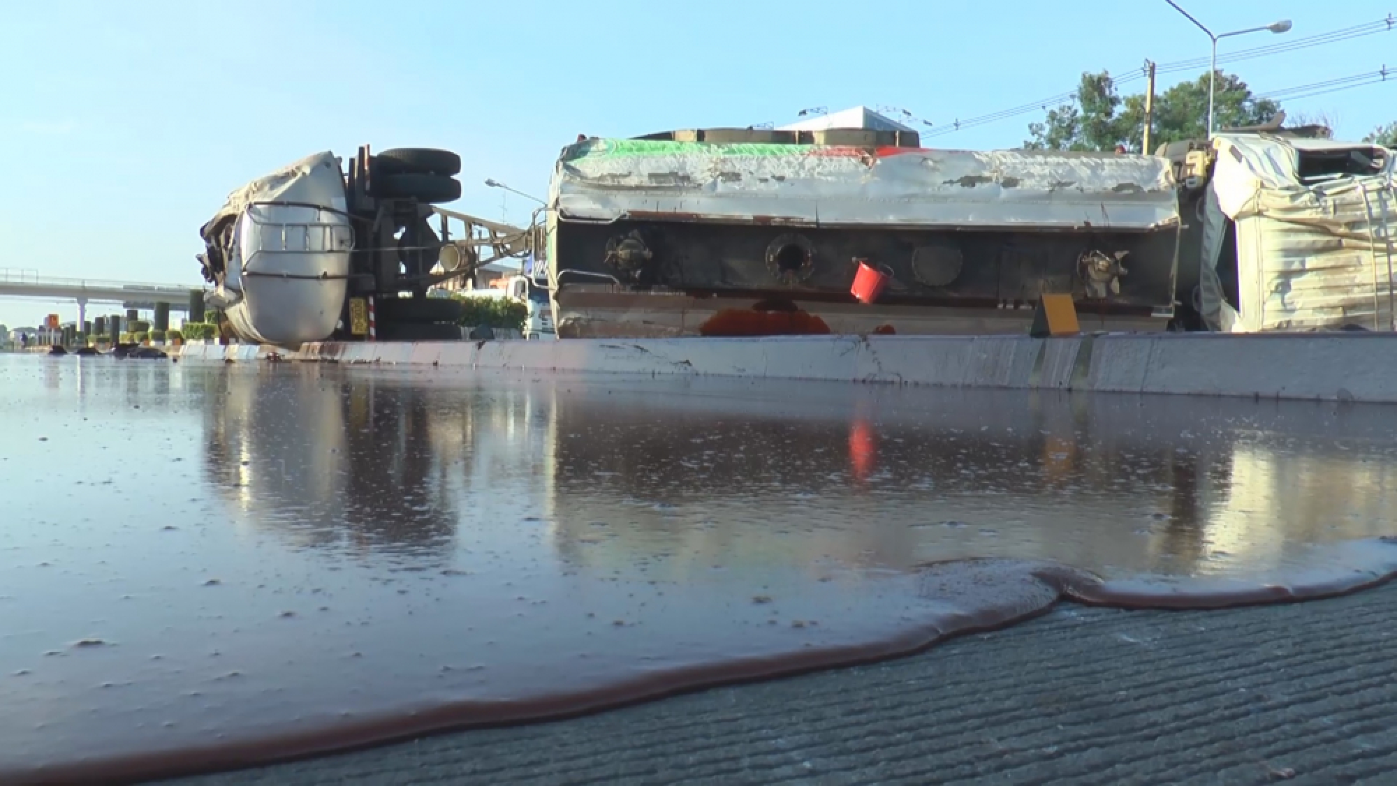 Tanker overturns, paves road with big molasses spill
