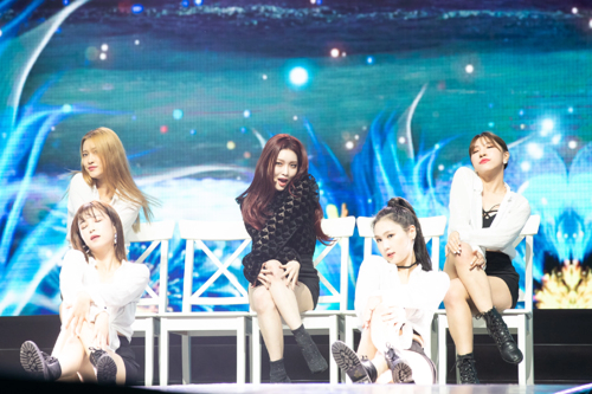 K-pop onstage, girls in puddles