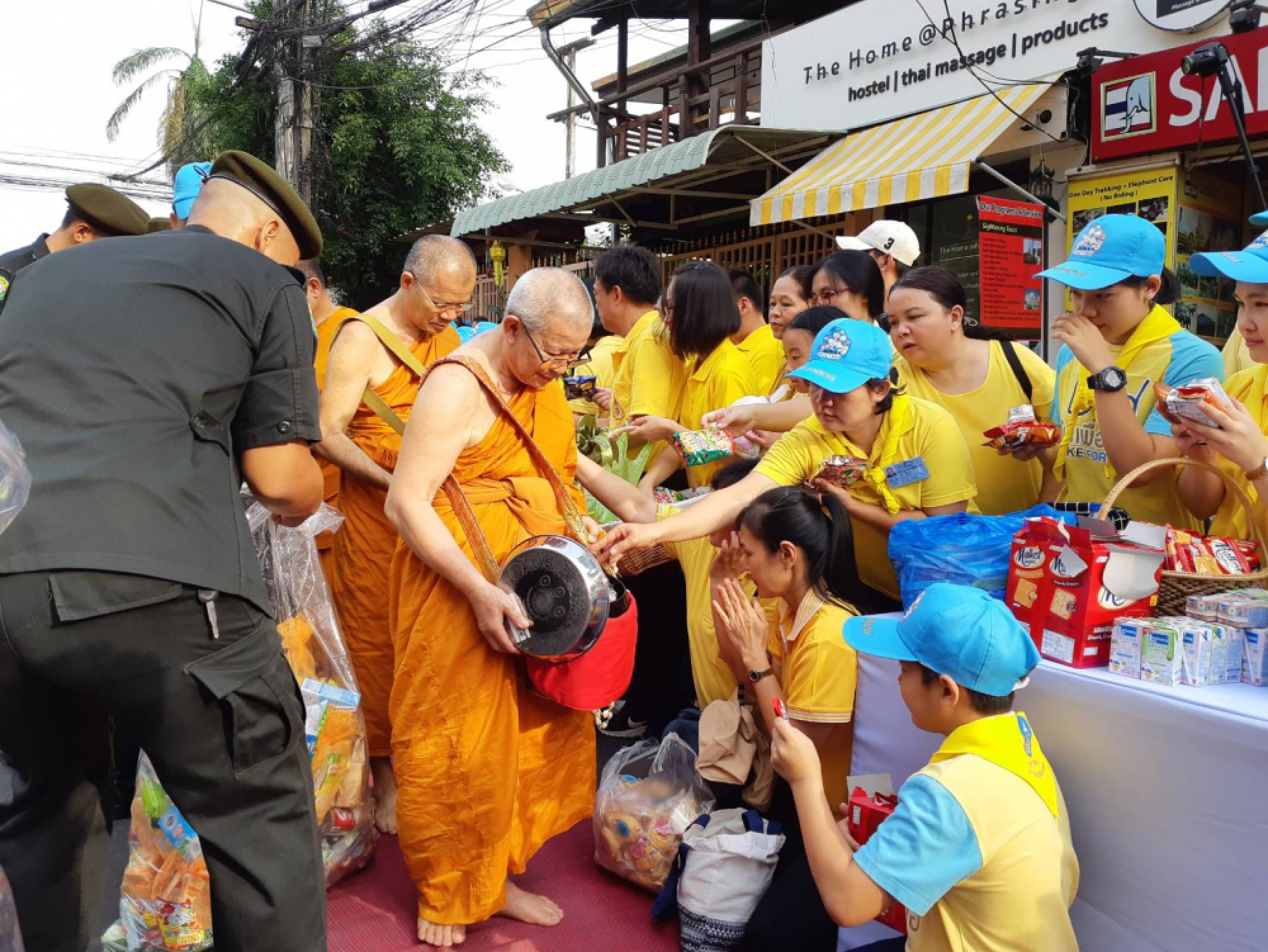 Yellow-clad Chiang Mai people give alms to 99 monks to mark royal coronation
