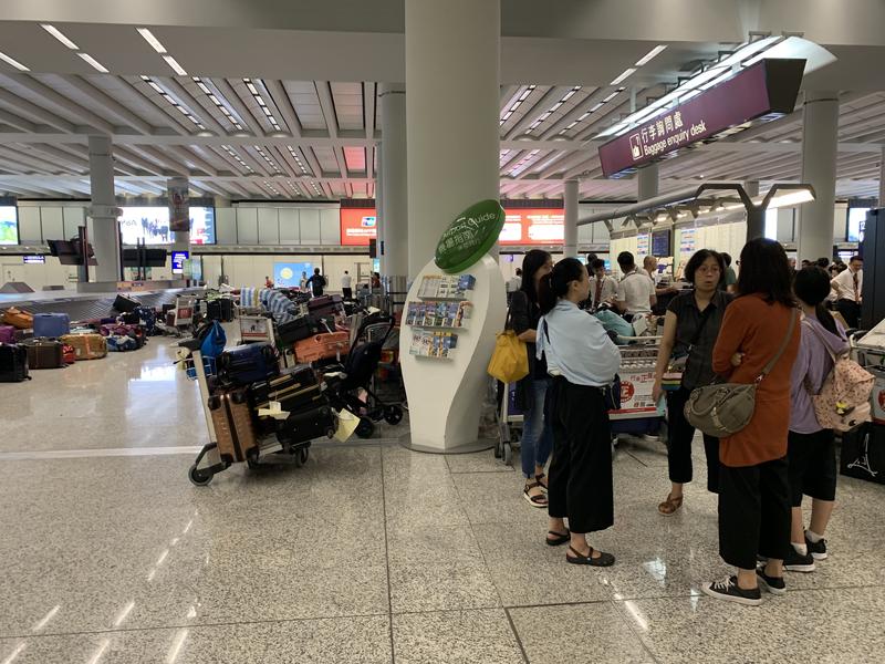 Passengers who had already checked in luggage to flights that were eventually cancelled, wait to claim their luggage at Hong Kong International Airport in the morning of Aug 13, 2019. (PHOTO / CHINA DAILY)