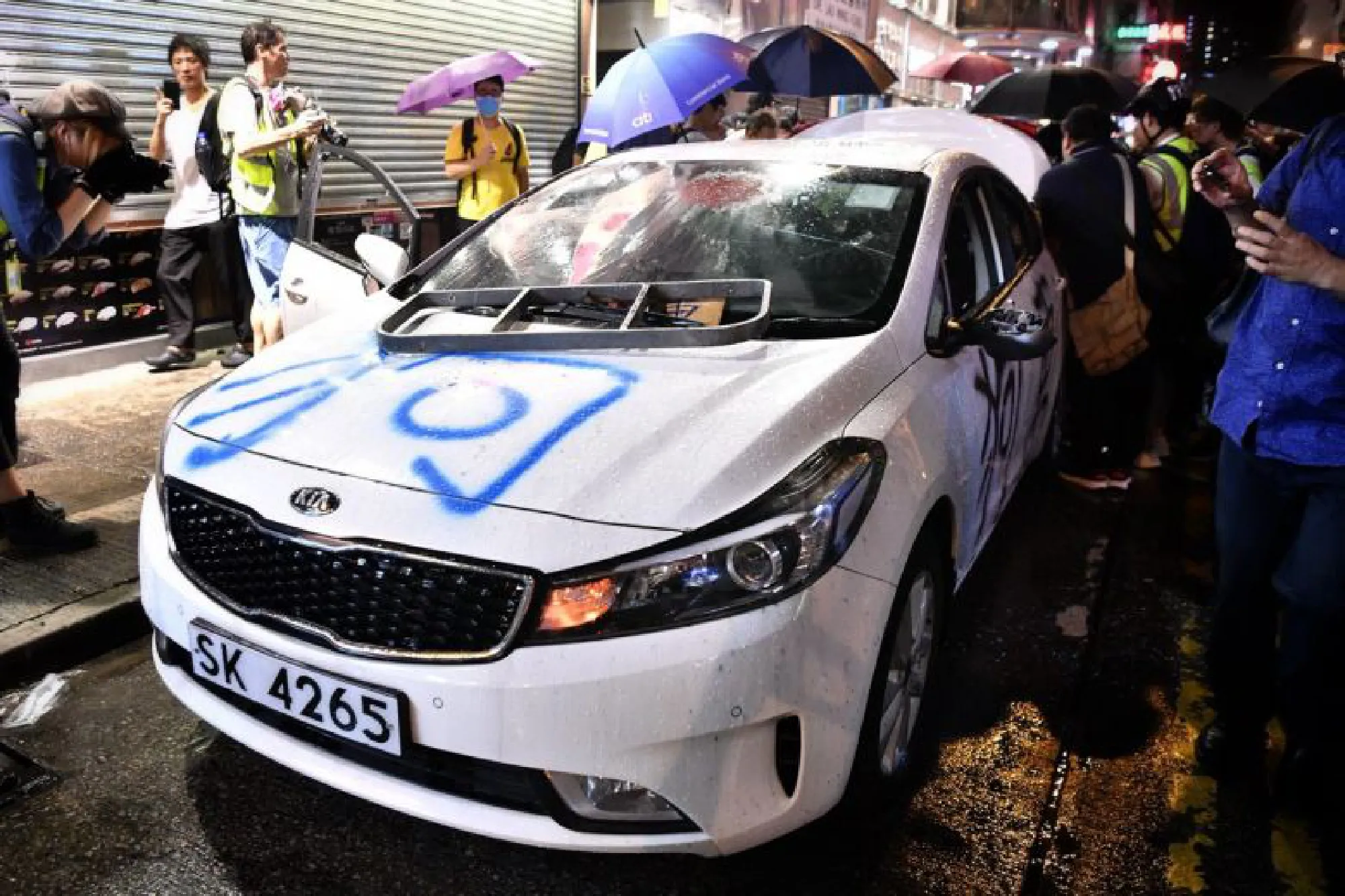 Protesters trash what they suspect to be an unmarked police car in Mong Kok, Hong Kong, on Oct 13, 2019.ST PHOTO: CHONG JUN LIANG