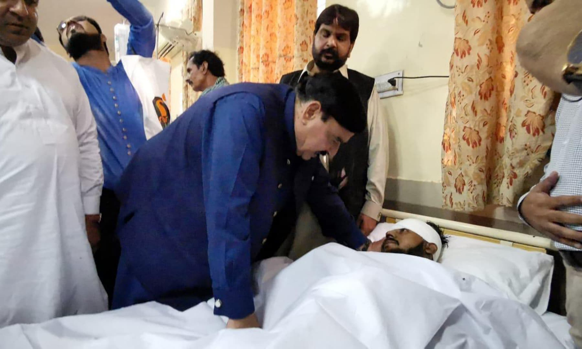 Railways Minister Sheikh Rashid Ahmed asking after a patient at the Sheikh Zayed Hospital in Rahim Yar Khan on Thursday. — Photo provided by Adnan Sheikh