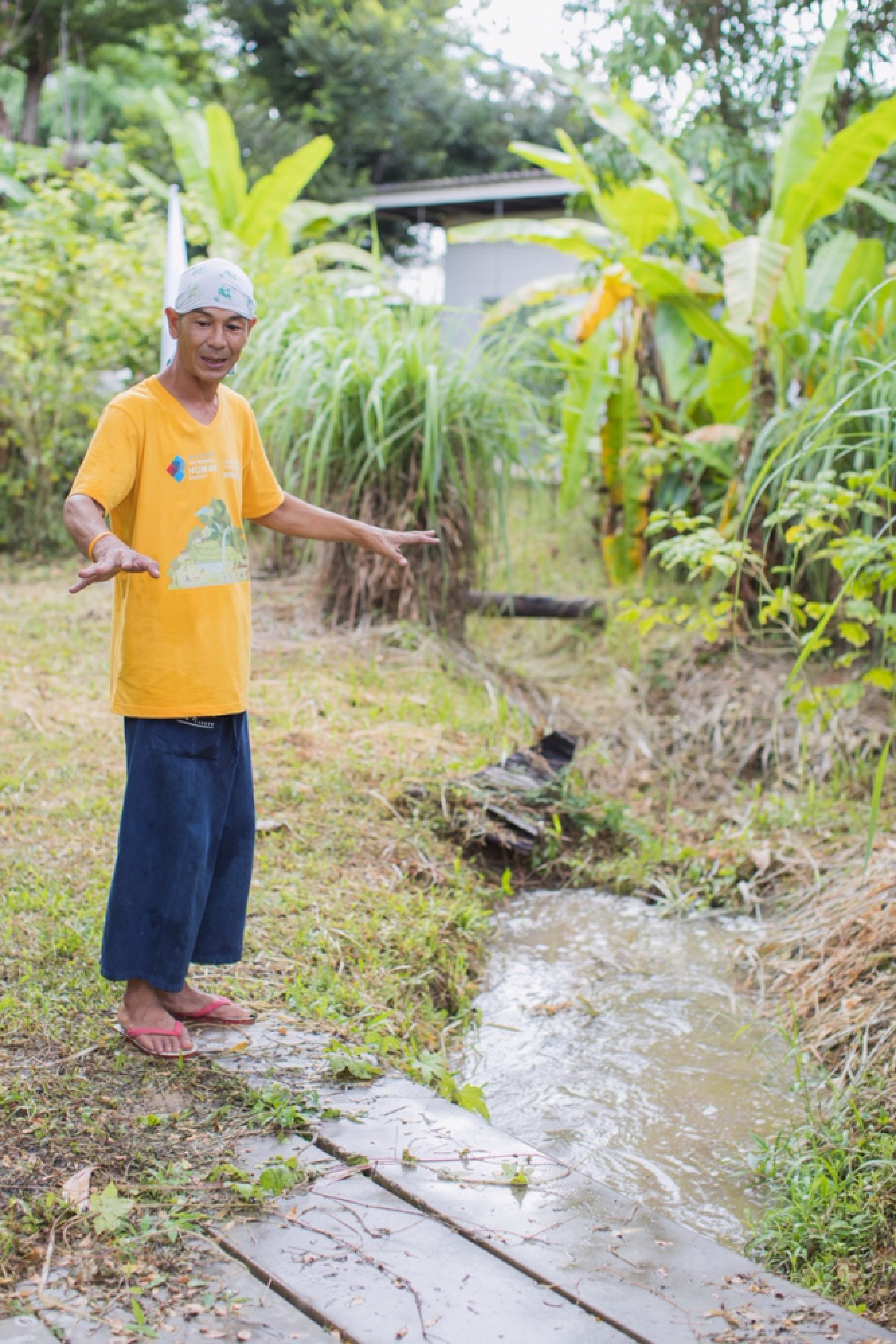 Torvong points to the canal that winds through his land.