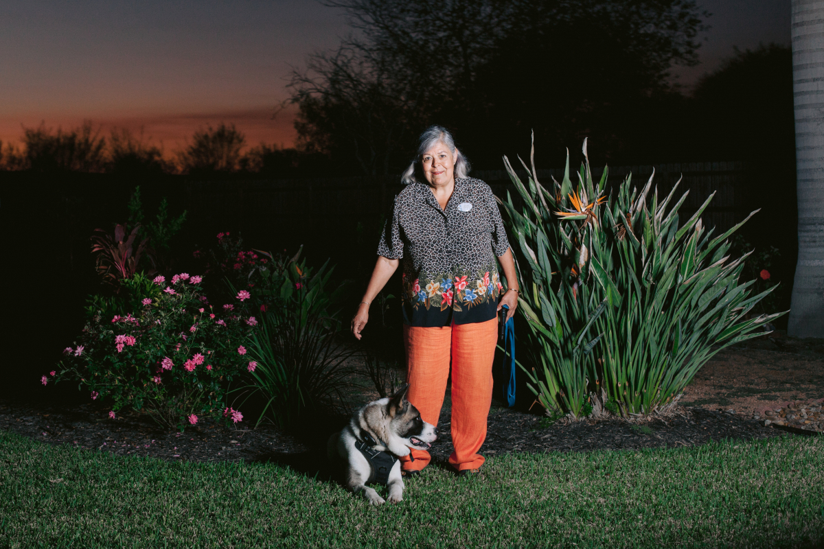 Elvia Carrasco and her dog, Guardian, next to her backyard garden in Brownsville, Texas. MUST CREDIT: Photo by Brenda Bazán for The Washington Post