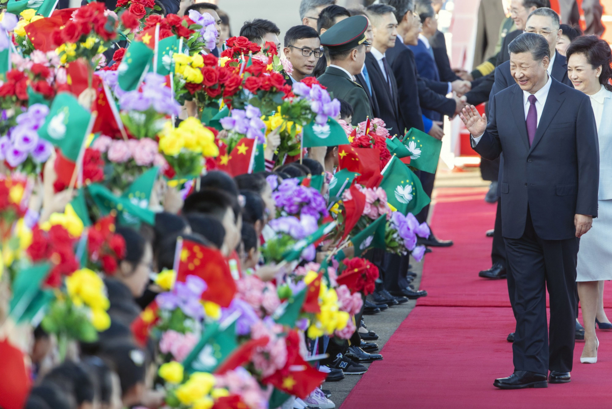 Chinese President Xi Jinping waves to children after arriving at Macau International Airport. CREDIT: Bloomberg photo by Justin Chin