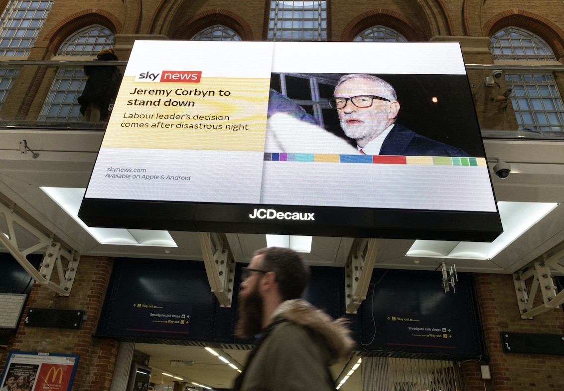 The Sky News channel broadcasts breaking news on the U.K. general election and leader of the Labour Party Jeremy Corbyn's resignation on a giant advertising screen at Liverpool Street railway station in London on Dec. 13, 2019. MUSTS CREDIT: Bloomberg photo by Bryn Colton.