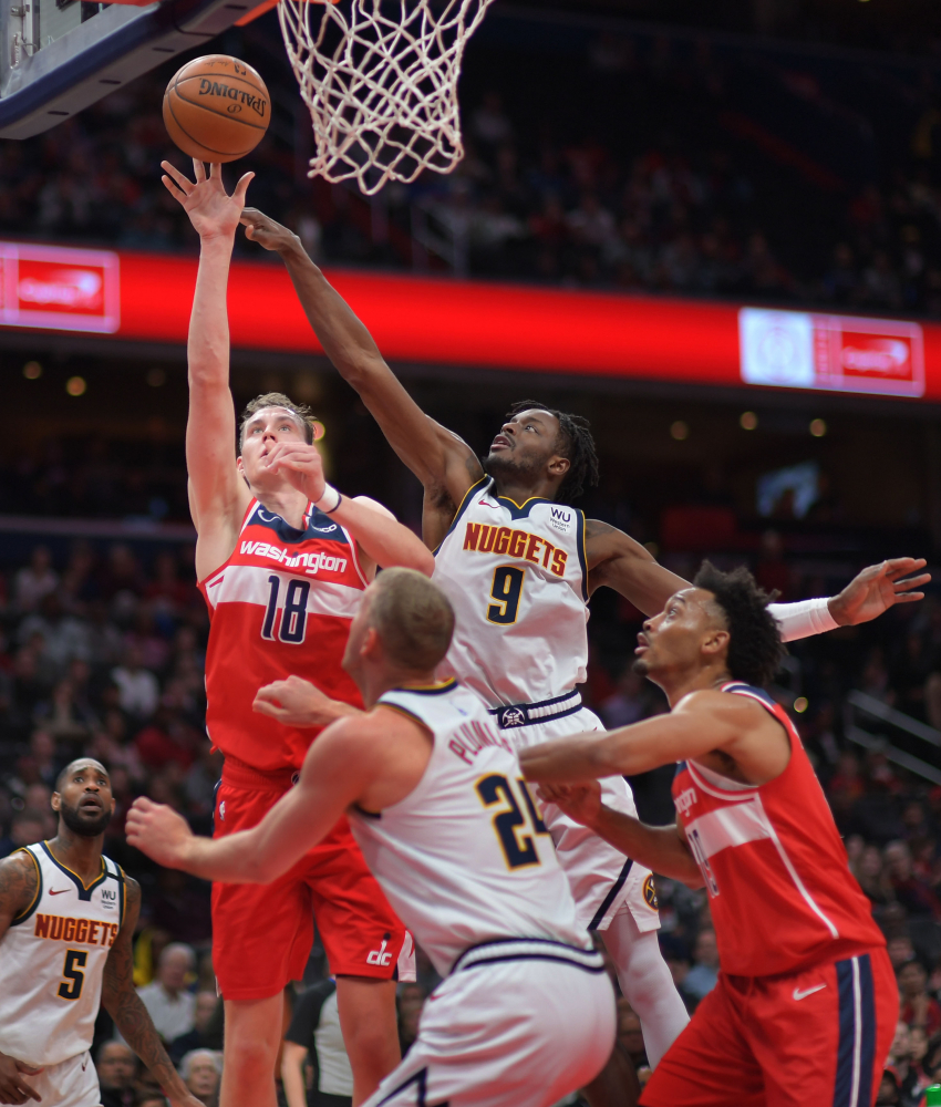 Wizards Anzejs Pasecniks scores over Nuggets forwards Jerami Grant (9) and Mason Plumlee during Saturday night's game. Pasecniks had 13 points in Washington's upset of Denver. MUST CREDIT: Washington Post photo by John McDonnell