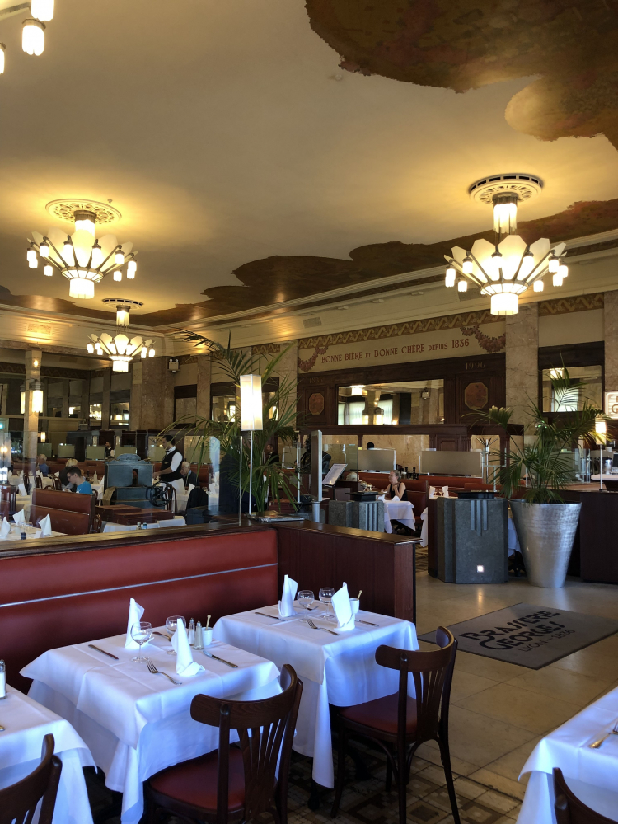 Red banquettes and art deco chandeliers adorn the elegant, historical dining room at Brasserie Georges. MUST CREDIT: Washington Post photo by Sylvie Bigar