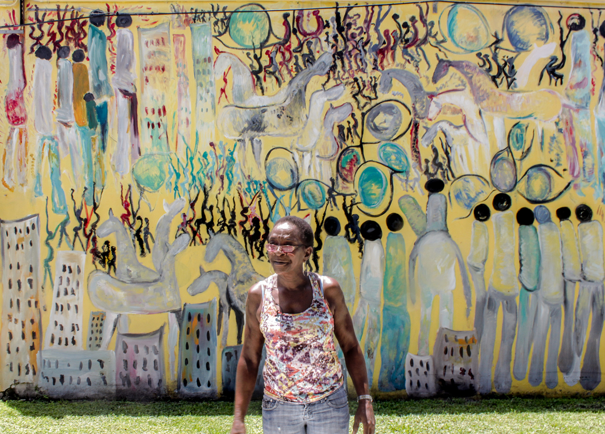 Eddie Mae Lovest, a close friend of Purvis Young's, in front of one of his murals. The artist willed most of his estate to her and her family. MUST CREDIT: Photo courtesy of KijiK Multimedia Inc.