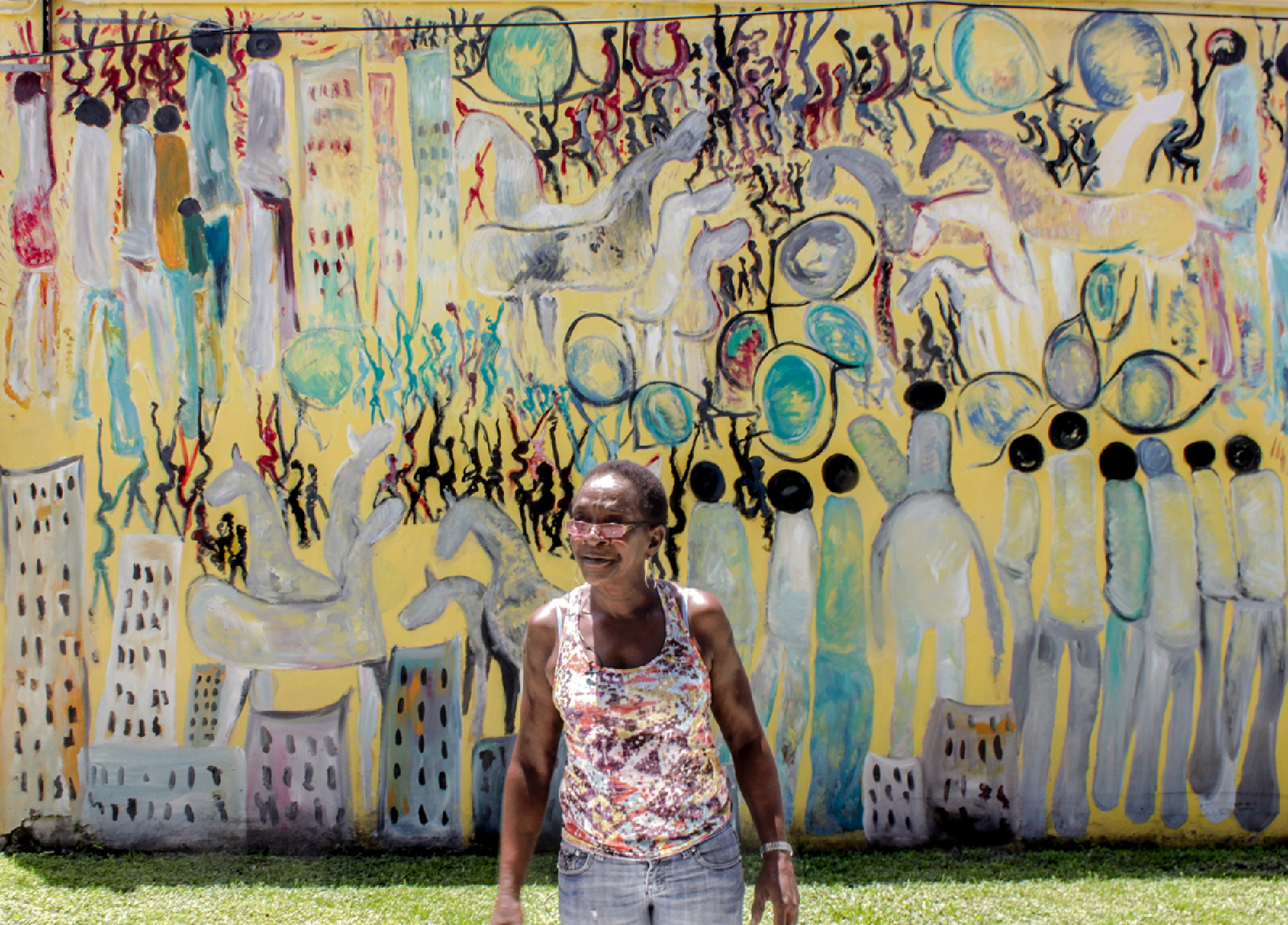 Eddie Mae Lovest, a close friend of Purvis Young's, in front of one of his murals. The artist willed most of his estate to her and her family. MUST CREDIT: Photo courtesy of KijiK Multimedia Inc.